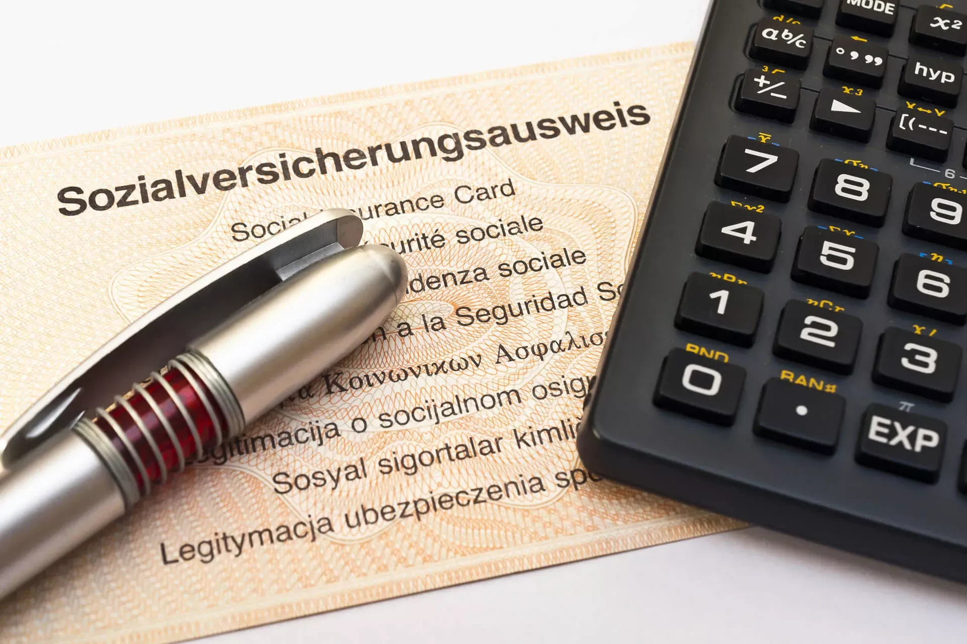Sozialversicherungsausweis mit Kugelschreiber und Taschenrechner. Sozialversicherungsausweis mit Kugelschreiber und Taschenrechner.