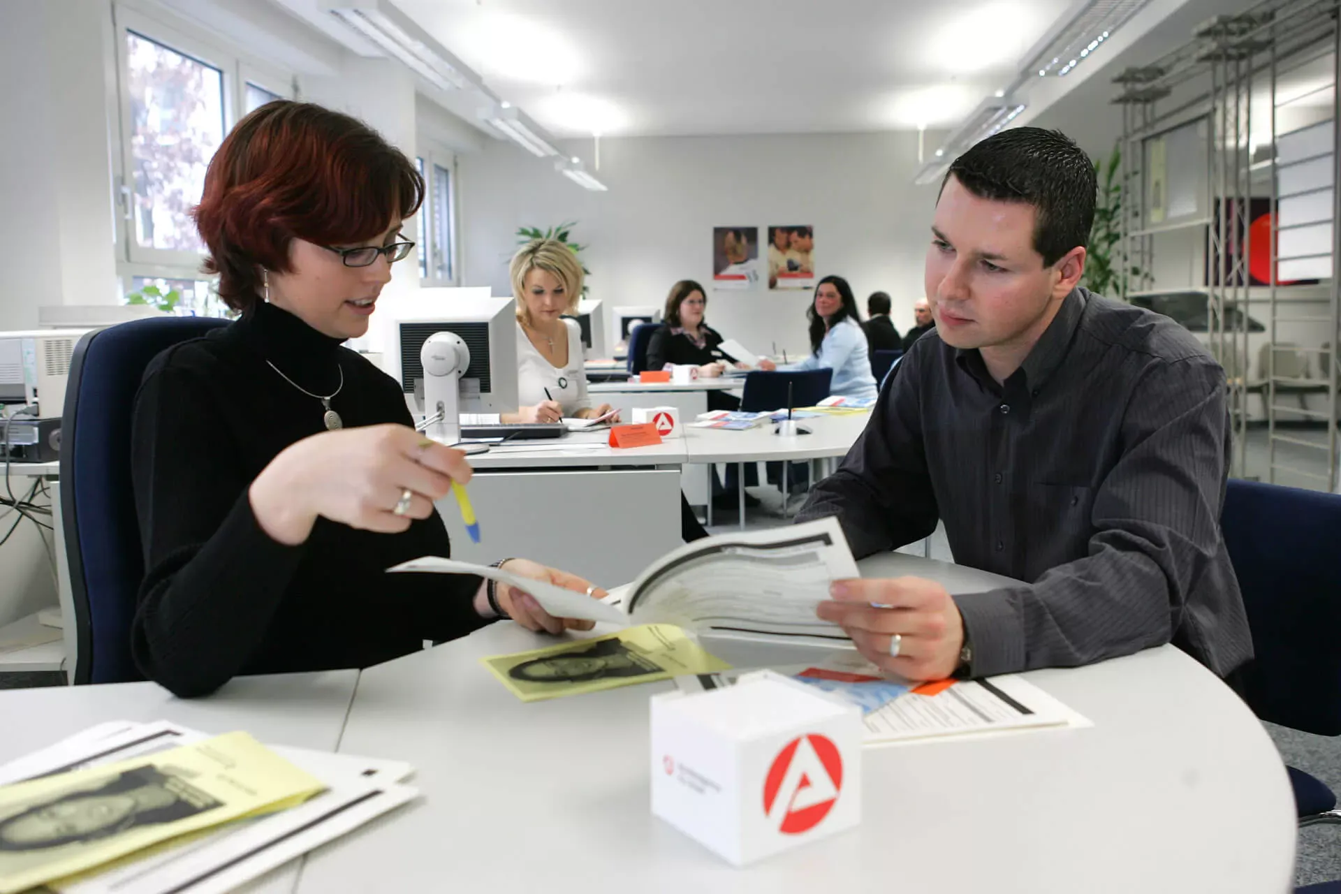 Sachbearbeiterin in der Arbeitsagentur spricht mit einem Arbeitssuchenden. Sachbearbeiterin in der Arbeitsagentur spricht mit einem Arbeitssuchenden.