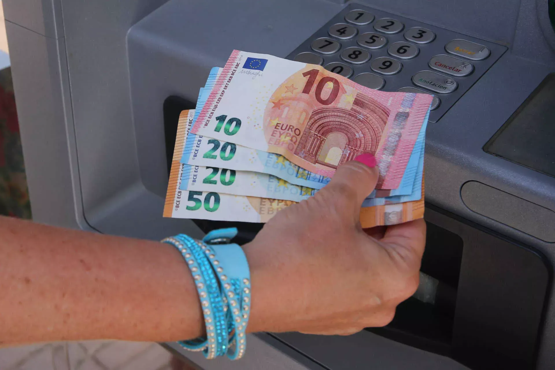 Frau hält Geldscheine in der Hand vor einem Bankomaten. Bild: IMAGO / localpic Frau hält Geldscheine in der Hand vor einem Bankomaten. Bild: IMAGO / localpic