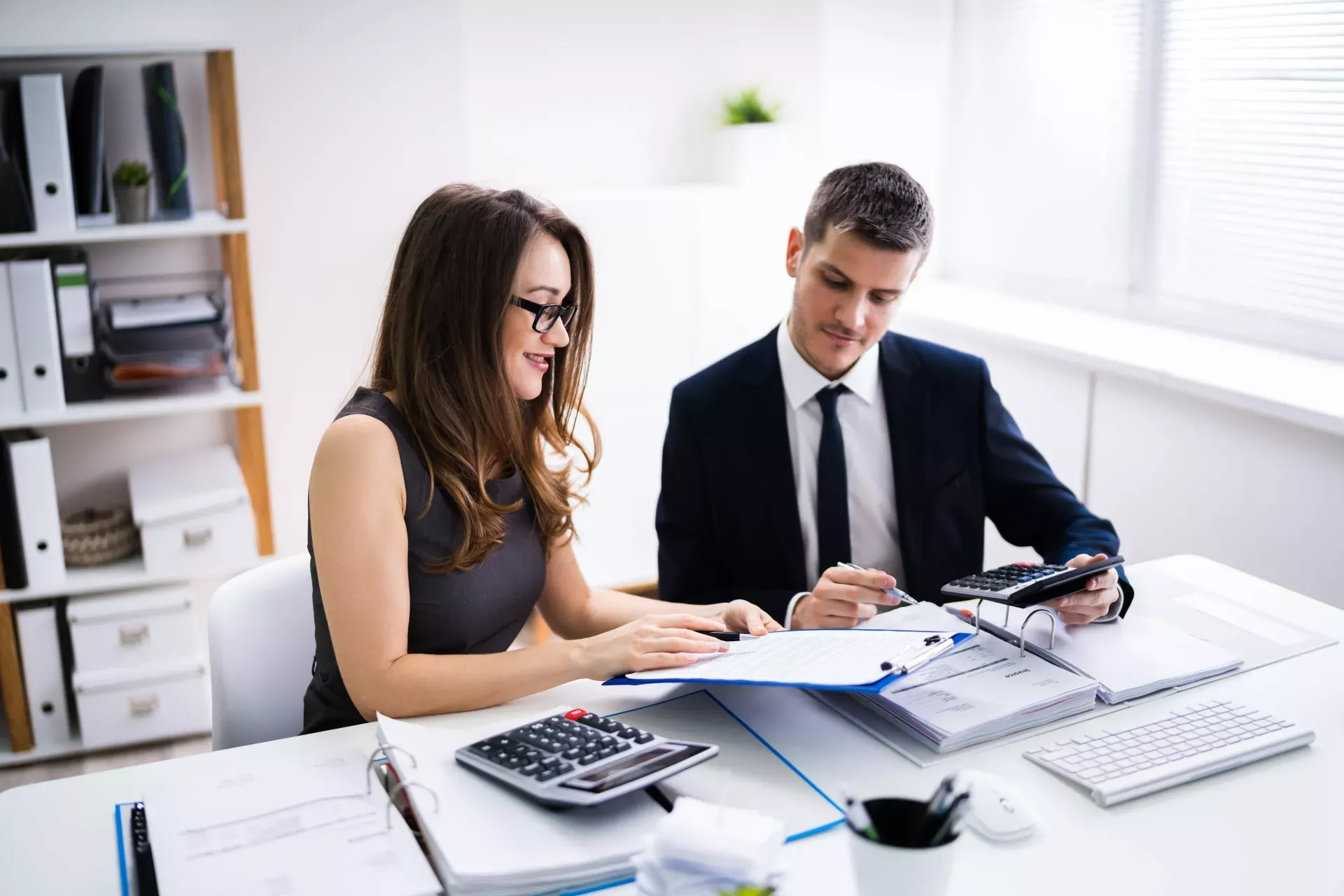 Mann und Frau im Büro arbeiten an Finanzanalysen. Mann und Frau im Büro arbeiten an Finanzanalysen.
