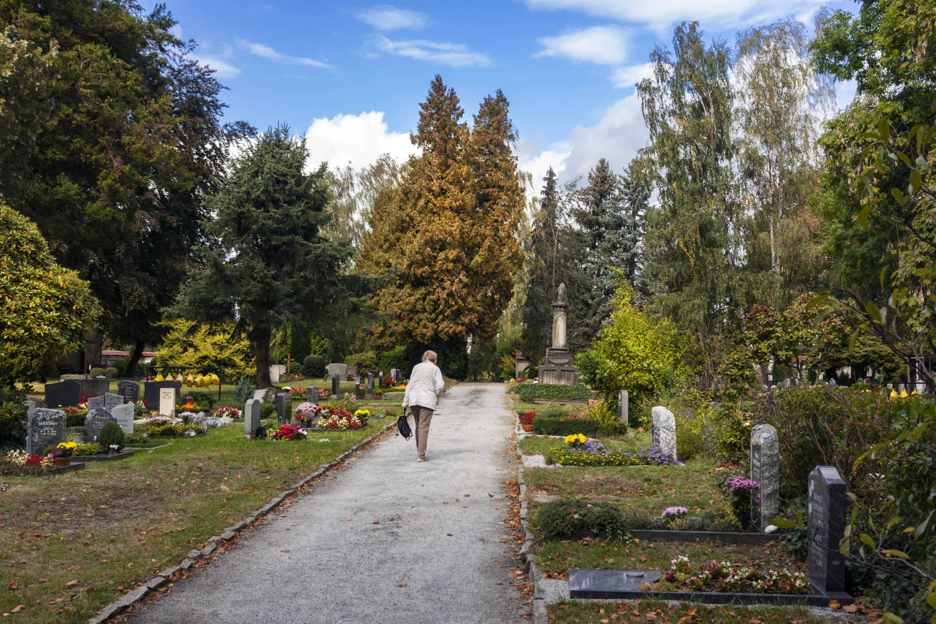 Seniorin geht auf einem Friedhof einen Weg entlang. Bild: IMAGO / Olaf Döring Seniorin geht auf einem Friedhof einen Weg entlang. Bild: IMAGO / Olaf Döring